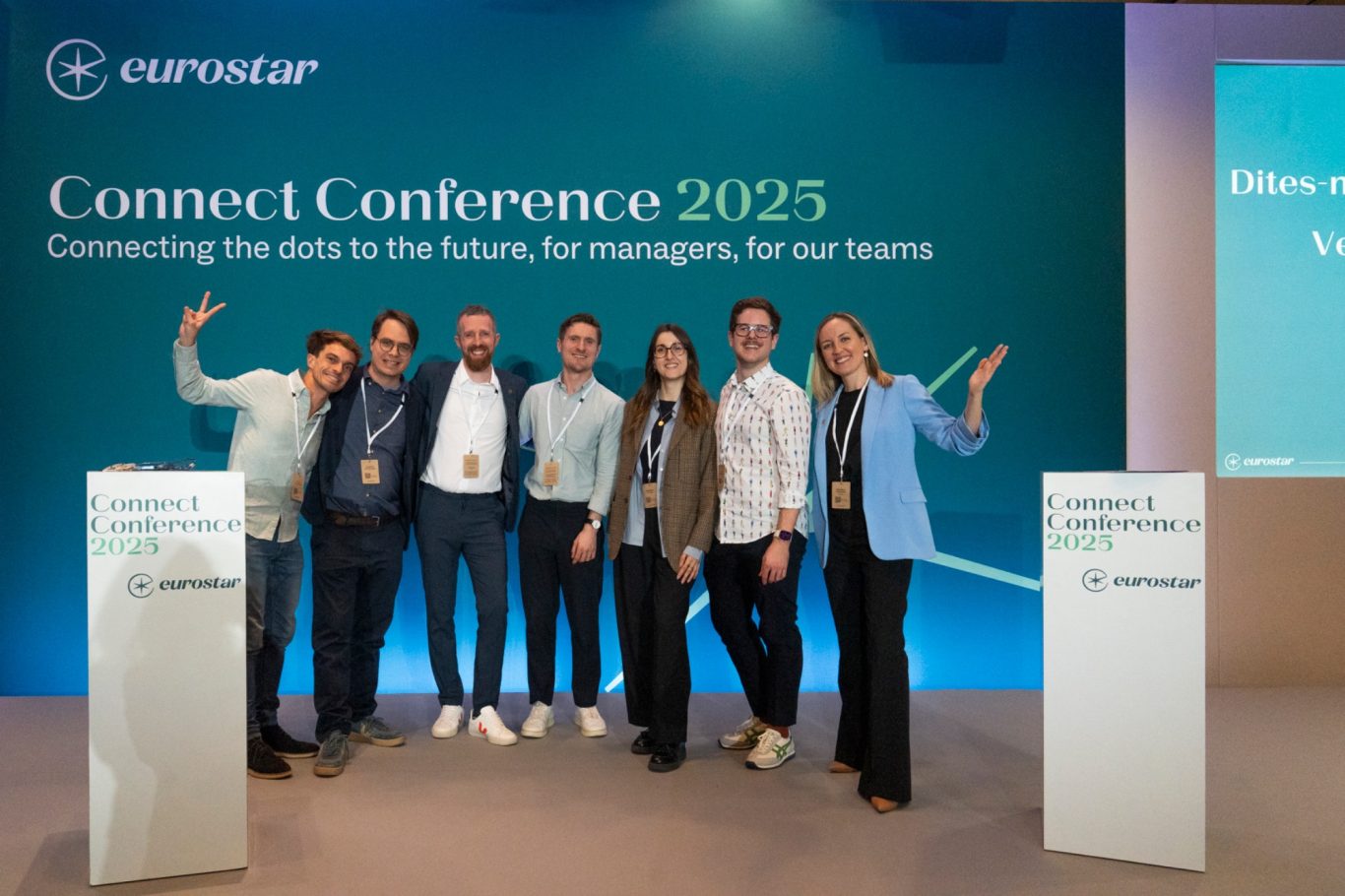 Bringing colleagues together and presenting a forum for information sharing, motivation and insights. JK stands alongside Eurostar colleagues on the stage of a corporate conference. Behind them reads 'Connect Conference 2025'.